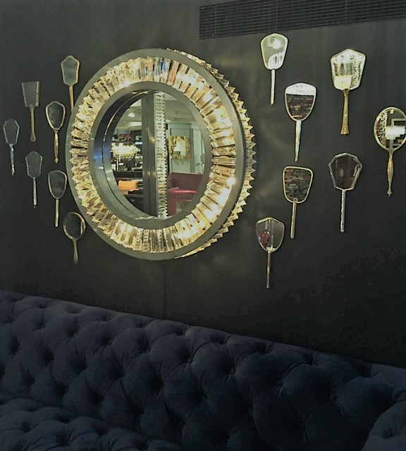 Gold Mirror Collection On A Dark Wall